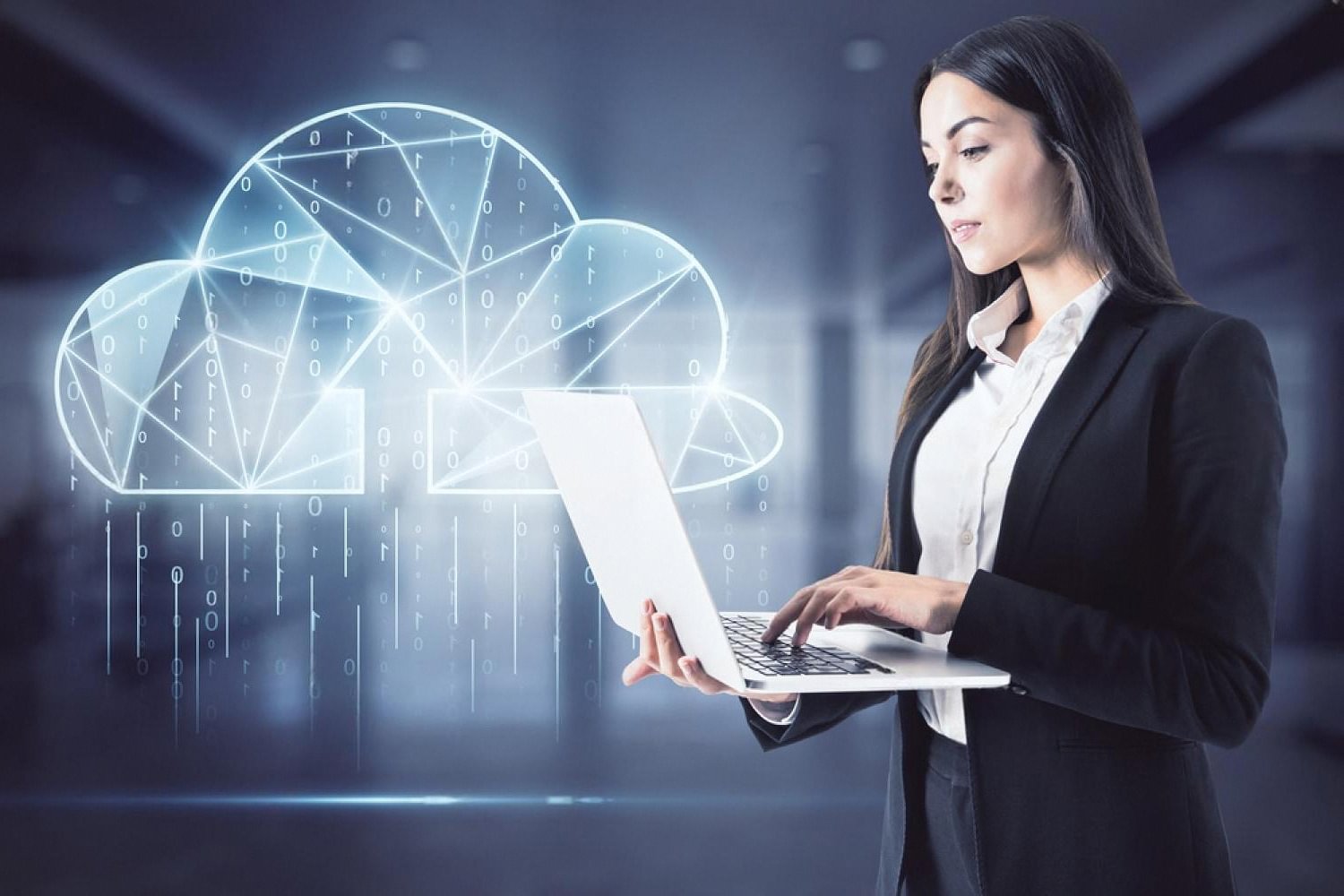 Female IT professional with laptop and cloud data overlay, representing an in-house IT team