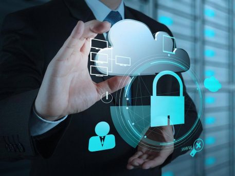 Business professional holding a cloud and padlock graphic, symbolising managed IT security in Dubai