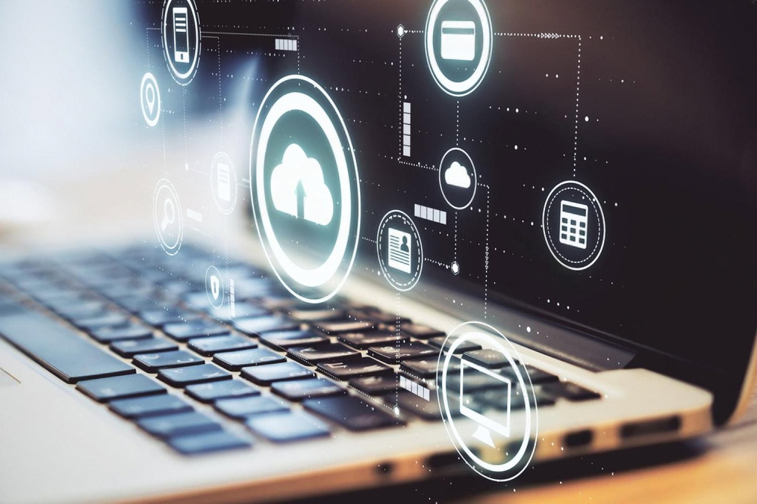 Laptop with cloud and IT service icons representing managed IT services for UAE businesses