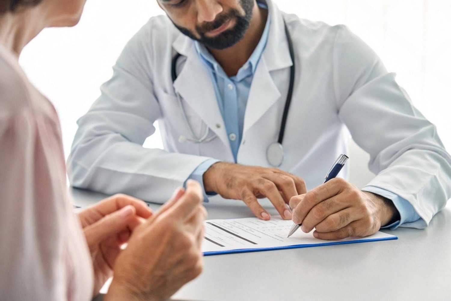 Doctor filling out a medical form during a bariatric surgery consultation