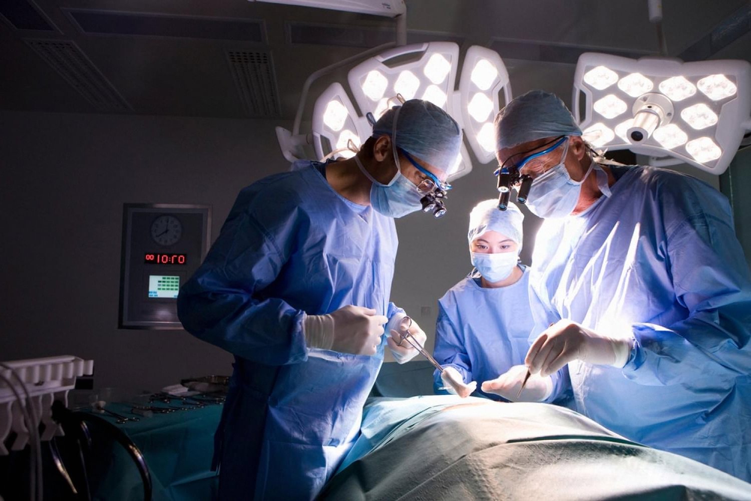 Bariatric surgeons operating under theatre lights during weight loss surgery